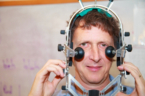 Linguist Jaye Padgett wearing the head frame used to stabilize an ultrasound camera. Padgett and colleagues at UC-Santa Cruz and University College Dublin are documenting Irish consonant formation. (Photo: Doug McKnight)