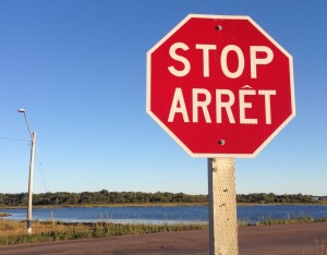 In France, stop signs read "Stop."  In Quebec, they read "Arrêt.” In New Brunswick, both words appear on stop signs.  (Photo: Emma Jacobs)